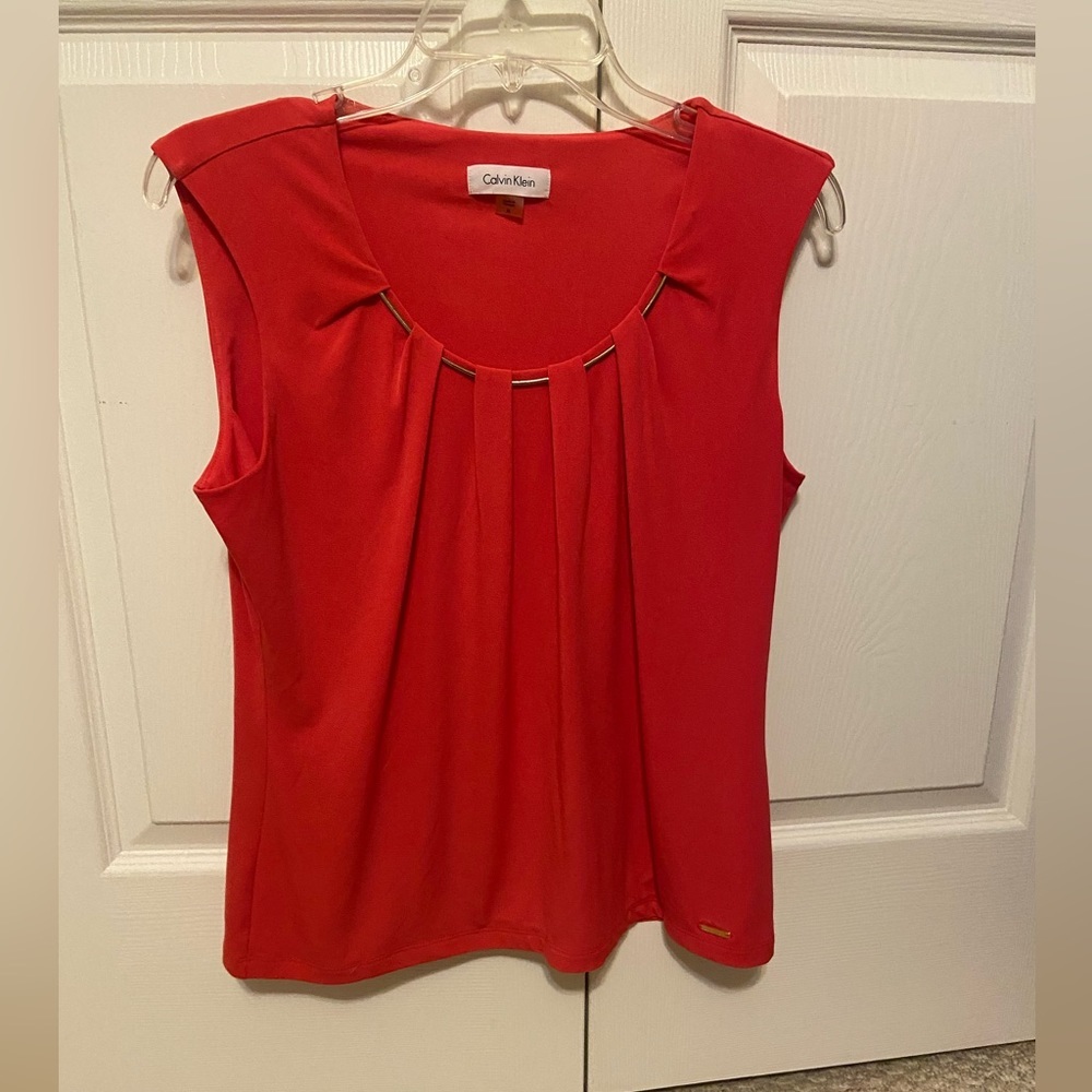 Calvin Klein coral poly/spandex sleeveless top with gold accent neckline